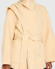 Beige coat worn by a person on a white background Woman wearing a light yellow coat against a beige background front view