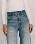 close up of a blue jean covered in rhinestones with a white long sleeve top