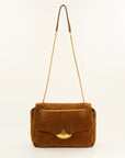 A brown suede shoulder bag with a gold-tone chain strap and a gold-tone fan-shaped clasp, shown against a plain off-white background.