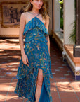 Woman wearing a blue floral dress on a sunlit patio