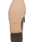 Top-down view of a Dolce Vita men's loafer sole, showing a dark brown leather upper, a tan insole with the brand name printed in black, and a black rubber outsole.