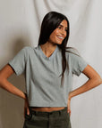 model wearing a heather grey t shirt and green pants on a white background