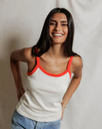 model wearing a tank and jeans against a white background
