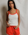 model wearing a matching tank and short set on a white background