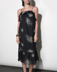 model wearing the Paige Layered Ruffle Midi Dress with strappy sandals on a white background, front