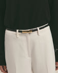 Person wearing a black sweater and light gray pants with The Lady Belt.