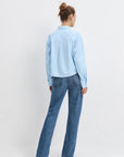 Model wearing the light blue stripe jenni top with jean and heels on a white background, back view
