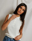 model wearing a white collared shirt with jeans on a white background