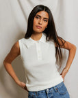 model wearing a white collared shirt with jeans on a white background