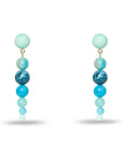 Pair of earrings with blue and green beads on a white background