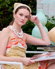 woman wearing a crochet headband with a colorful background