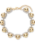 Gold necklace with spherical beads and chain on a white background