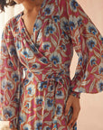 Floral patterned robe worn by a person on a neutral background