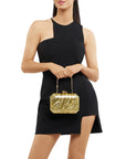 Mateo Metallic Clutch held by model with top handle