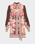 A long-sleeve collared shirt dress featuring a pink and beige floral print over a brown and beige striped base, with a matching tie belt at the waist.