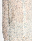 Floral patterned shirt with light blue flowers on a beige background