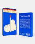 Blue matchbox with a graphic of a match and a book titled 'Catch a Fire by Sebastian Curi'.