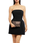A woman modeling a strapless black mini dress with a structured bodice and holding a rectangular clutch bag with a brown pattern and a metallic silver diamond mesh overlay, shown on a plain white background.
