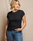 Woman wearing a black t-shirt and blue jeans against a beige background, size L