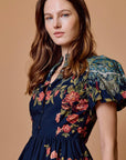 model wearing sveti mini dress on tan background