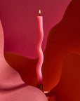 Wavy pink candle on a abstract red and pink background