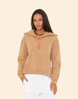 Woman wearing Kat Sweatshirt on a beige background