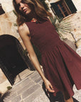 Woman in a Adobe Brown Florie Dress standing outdoors on a stone path.