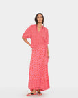 Woman wearing a pink floral dress on a white background