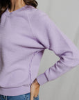 detail photo of a model wearing a purple sweatshirt