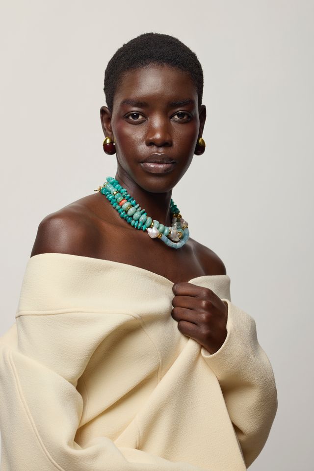 Toro Earrings in Aubergine on model with turquoise necklaces 