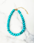 Turquoise beaded necklace on a marble surface