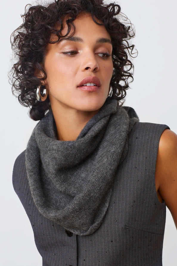 Woman wearing a gray scarf against a white background
