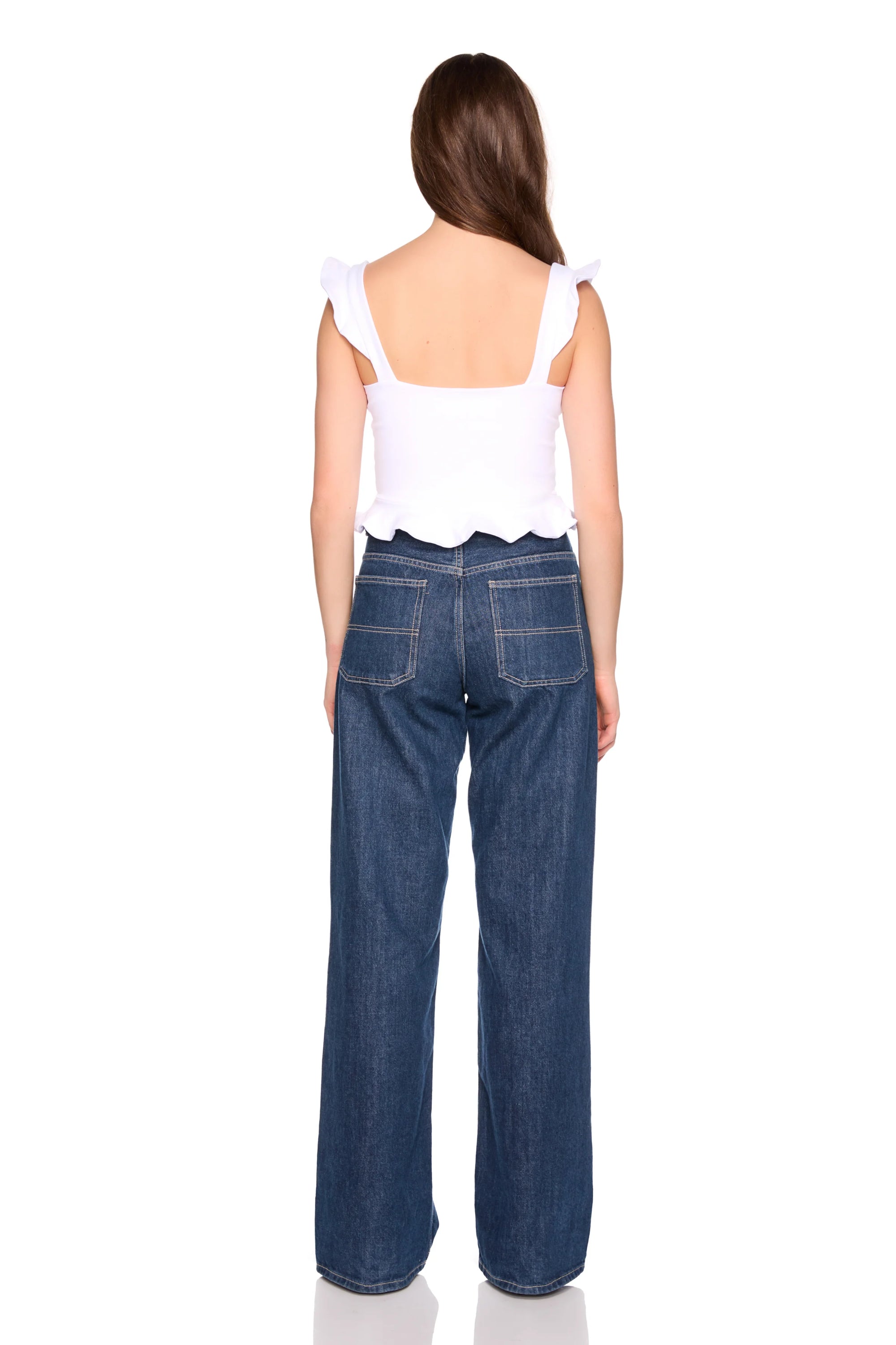 Woman wearing blue jeans and a white top on a white background, back view