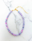 Necklace with pastel beads on a marble surface