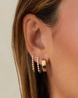 Single Multi Diamond Bezel Chain Stud Earring on ear in second and third holes