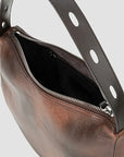 Close-up of a brown leather shoulder bag with an open top zipper, showing a black interior lining and a dark brown strap with oval cutouts against a light gray background.