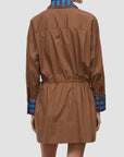 A model shown from the back wearing a brown mini jacket with a striped blue and red collar and cuffs, set against a plain light gray background.