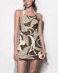 Woman wearing a patterned dress on a white background
