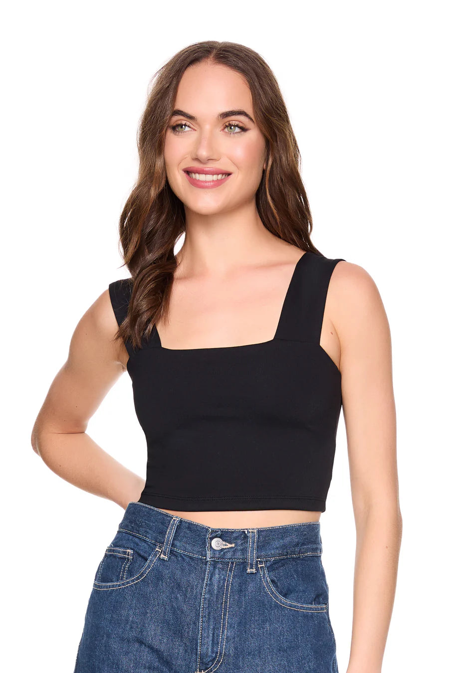 Woman wearing a black tank top and blue jeans on a white background, close up front