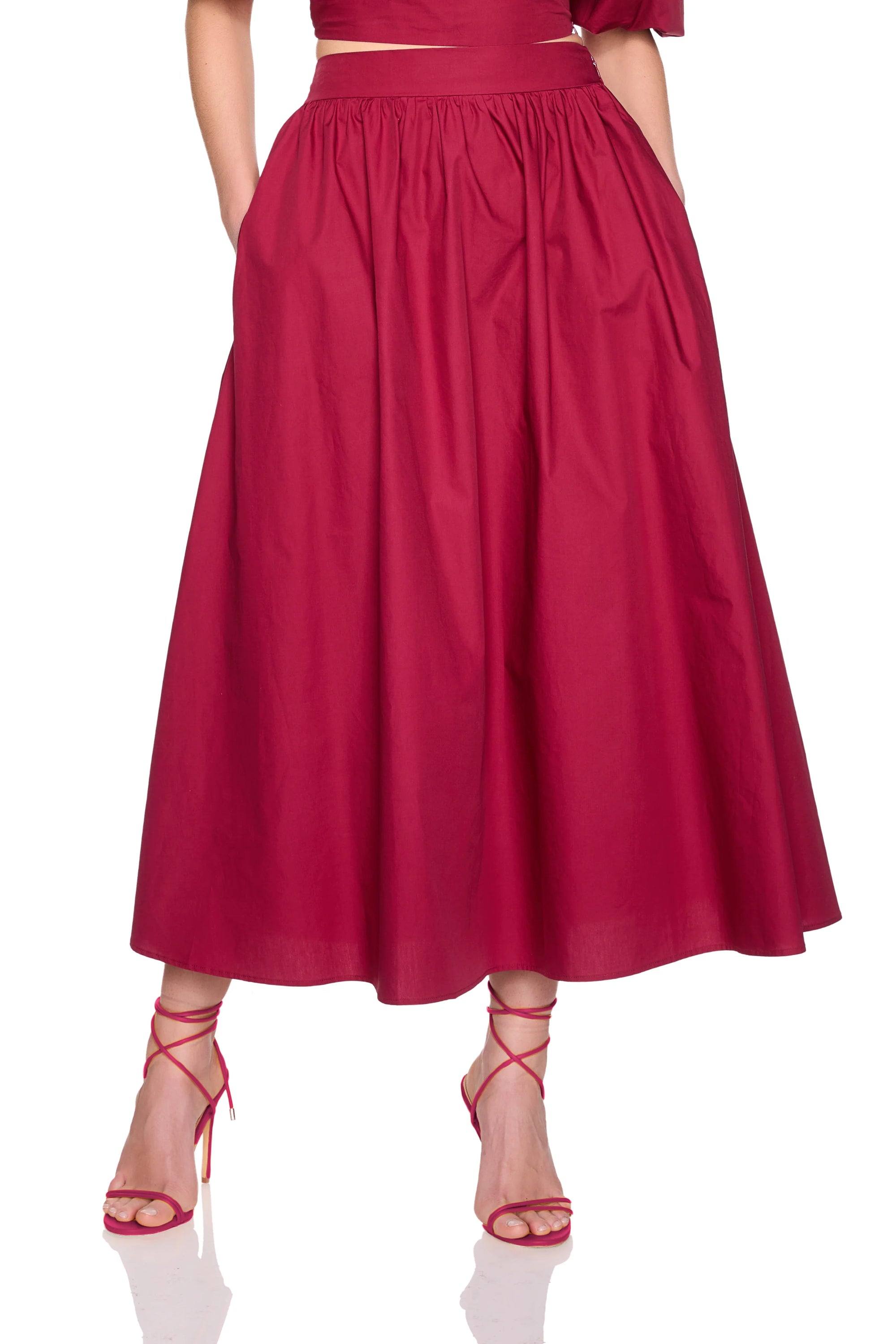 model wearing a midi skirt on a white background
