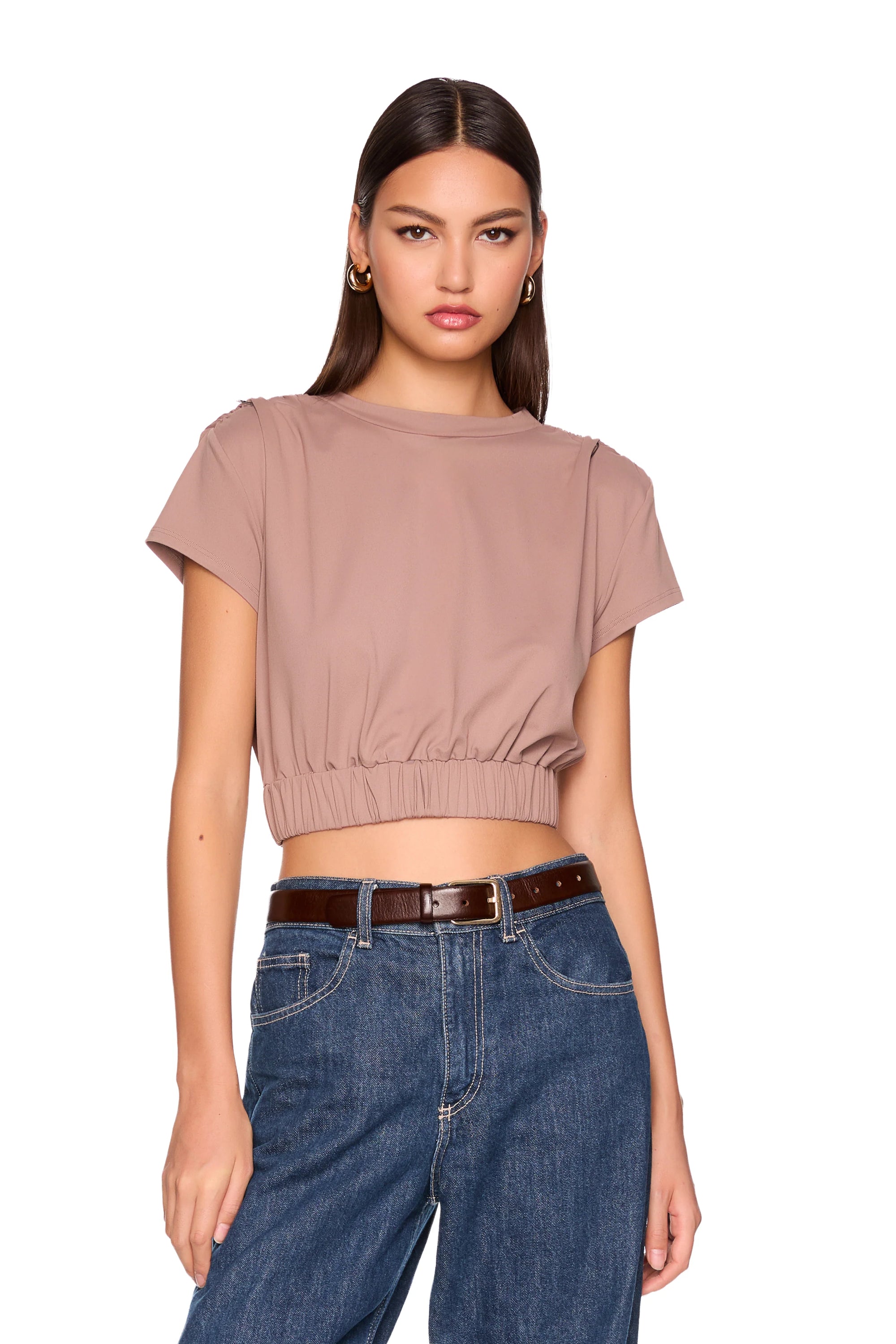 model wearing coco tee gathered at waist with jeans on a white background