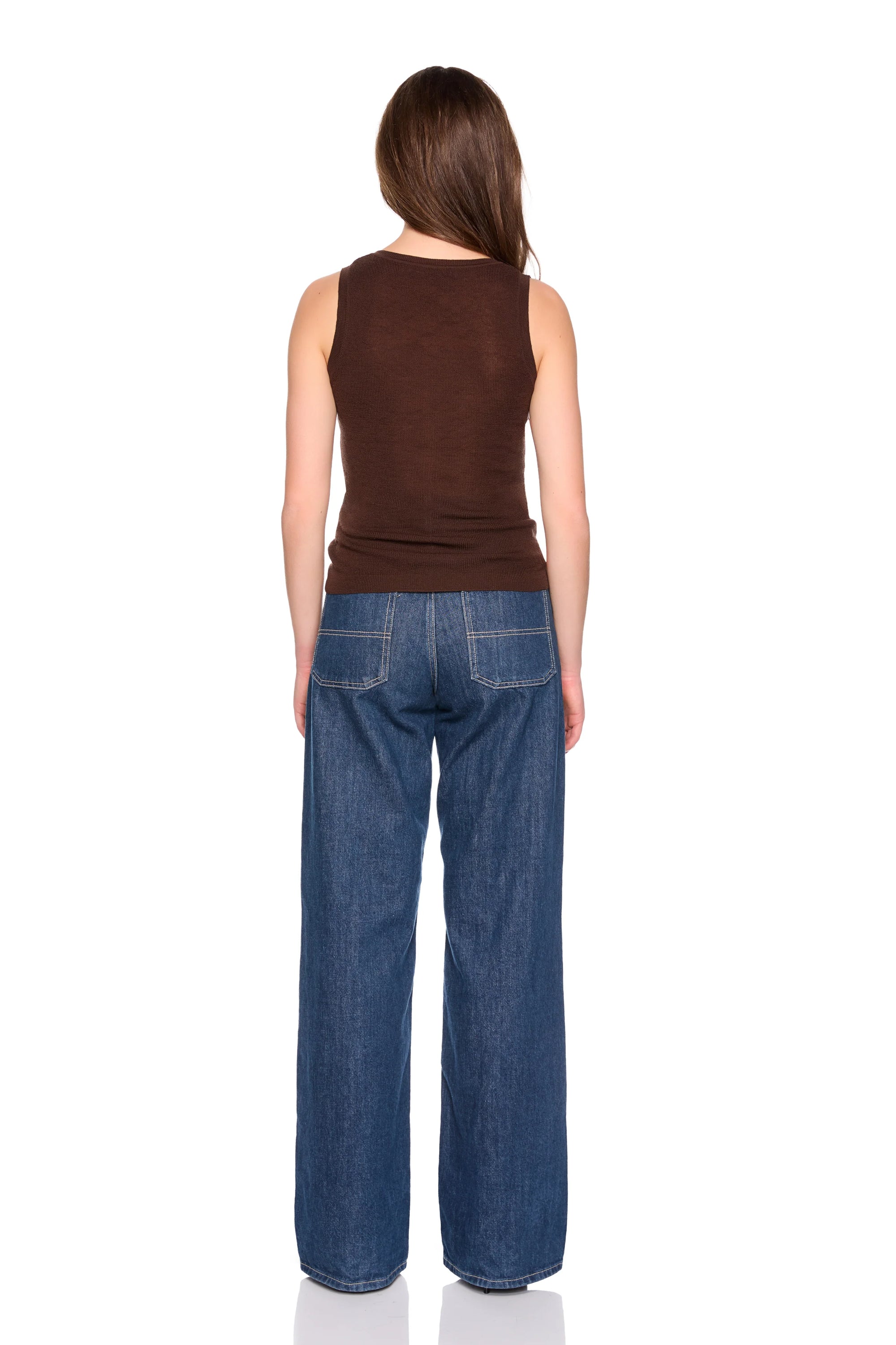 A woman shown from the back wearing a brown sleeveless top and wide-leg blue jeans against a plain white background.