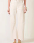model wearing a bone colored utility jean / pant with a brown tank on a white background 