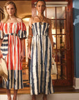 Two women wearing striped dresses standing in a doorway.