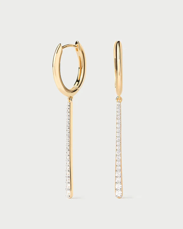 Gold hoop earrings with diamond drop pendants on a light gray background