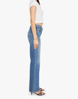 Woman wearing a white top and blue jeans on a white background