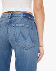 Close-up of blue jeans with a brand logo on a white background