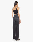 Woman wearing black high-waisted jeans and a black crop top on a white background, back view