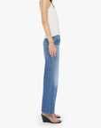 Woman wearing a white top and blue jeans on a white background