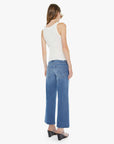 Woman wearing a white sleeveless top and blue jeans on a white background